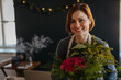 © Halfpoint - Smiling female florist working in her small flower shop.