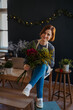 © Halfpoint - Smiling female florist working in her small flower shop.