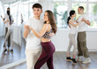 © JackF - Young people learning tango dance at lessons in dance studio