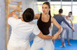 © JackF - Young woman and young man practicing self-defense techniques in gym..