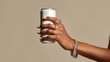 © InfiniteStudio - Elegant hand holds a beverage can adorned with sparkling rings and bracelets during a stylish photo shoot