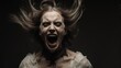 © grez - Frightened woman screaming in the dark, horror and fear concept.