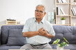 © 220 Selfmade studio - Asian Senior man chest pain heart attack emergency health care elder living room sofa glasses grey hair