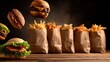 © Dara - Various food items, including burgers and fries, arranged on a wooden table with bags of fries in the background.