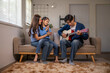 © Apichat - Asian family enjoying music at home, father playing guitar