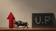 © Line - Red arrow and bull figurine beside chalkboard with UP text