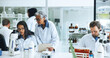 © SiphosethuFan/peopleimages.com - Coworking, science or people with microscope in lab, blood sample analysis or experiment for pathology. Medical research, study reaction or scientist team with report file, trial or test feedback