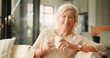 © peopleimages.com - Happy, coffee and portrait of senior woman on sofa in home with relax in retirement in living room. Smile, tea and elderly female person drinking warm beverage in morning with rest, calm or peace.