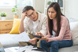 © KMPZZZ - Stressed financial owe asian young couple love sitting suffer, stressed and confused by calculate expense from credit card bill, no money to pay, mortgage or loan. Debt, bankrupt or bankruptcy people.