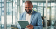 © PeakCC/peopleimages.com - Tablet, business and happy black man in company for financial report, email or communication. Tech, mature consultant and person in office with investment feedback, wealth management or research