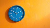 A blue wall clock showing 10:10 mounted on a textured yellow wall—evoking themes of time, contrast, symmetry, anticipation, and the visual choreography of routine, rhythm, and quiet urgency.