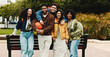 © peopleimages.com - Portrait, friends or college student with hug by bench on campus, education support or outdoor on study break. Embrace, diversity and happy people bonding together, care and knowledge with basketball
