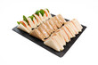 © DondykRiga - Assortment of finger sandwiches on black slate platter
