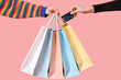 © Pixel-Shot - Female hands with shopping bags and credit card on pink background