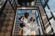 © qunica.com - A group of colleagues gathers around a white table, reviewing documents and charts in a bright, contemporary office.