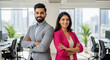 © Niks Ads - A professional Indian man and woman stand confidently with arms crossed in a modern office