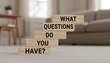 © hubaib - Wooden blocks stacked in ascending order spelling out 'What Questions Do You Have?'.