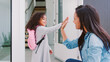 © Monkey Business - Mother Giving Daughter High Five As She Leaves For School