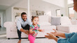 © Monkey Business - Family At Home Encouraging Baby Daughter To Take First Steps