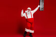 © deagreez - Santa dances with a boombox in a red studio for festive energy and holiday fun