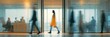 © Strive Studio - Blurred business people moving quickly through a modern office hallway.