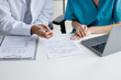 © mojo_cp - Doctor and nurse consulting on patient medical record in hospital