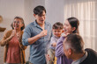 © Thitiporn - Happy Asian multigenerational family dancing and celebrating together at home, with joyful expressions and bonding moments, reflecting love, parenting, and vibrant family lifestyle.
