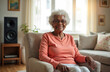 © Vadym - Elderly black woman sitting in armchair in living room. Mature adult female relaxes in cozy home environment. Happy grandmother with white hair enjoys quiet time indoors.