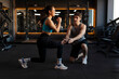 © Home-stock - Woman doing squats and lunges exercises while trainer providing guidance, lady focused on improving skills during training session