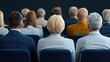 © Nucharee - Audience behind view in a conference setting.