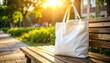 © Doulosa - White Tote Bag on Park Bench in Sunny Setting