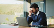 © BuyOutFelix05/peopleimages.com - Tired, businessman and headache with laptop, stress or overworked for deadline pressure in office. Frustrated, man or employee with migraine, fatigue or burnout for pain or mental health in workplace