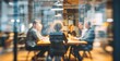 © lin - blurred photo of business people sitting around the table in an office, captured from behind and in focus, symbolizing collaboration within  company or between different quaint style icons.