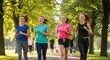 © Khasani - Group of Young Women Enjoying a Fun Run in the Park