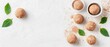 © Tetiana - Desserts flat lay composition. Gluten-free, low-carb balls with cocoa powder. Mint leaves on textured white surface. Sweet treats in bowls. Healthy diet concept.