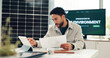 © FrameOn/peopleimages.com - Business, man and document with tablet in office for report, energy saving stats and sustainable. Person, digital and paperwork on photovoltaic grid revenue, environment results and solar panel sales