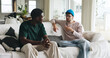 © AzeemudDeen25/peopleimages.com - Men, friends or discussion on sofa with gossip for life update, bonding together or weekend hangout. People, chill or relax with conversation for advice, wellness or storytelling in home living room.