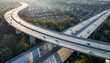 © Amity - Aerial view of elevated highway interchange with curved roads and vehicles in suburban area