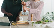 © peopleimages.com - Hands, people and cooking with tablet at house for online recipe, meal prep and organic ingredients. Friends, digital and seasoning for Italian pizza, tutorial and culinary skills for homemade lunch