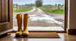 © val_webart - Yellow rain boots by open door on gravel path in countryside