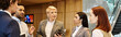 © Bliss - Group of professionals engaged in a dynamic discussion in a modern office space