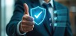 © Vadym - Man in suit gives thumb up near glowing shield with check mark. Confirms quality assurance process. Business success symbol. Approves checklist complete. Digital safety guarantee.