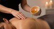 © D-point - Woman receiving a hot oil massage in spa. Relaxing spa treatment for wellness and skin care. Beauty and therapy concept.