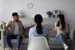 © Prostock-studio - A professional psychologist guides an arab couple through a marital therapy session. The couple expresses concerns while the therapist listens with focus. The setting is a cozy office space.