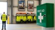 © Sameer - Professional workplace safety with prominent first aid kit and high visibility vests ready for industrial team preparedness