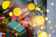 © Oleg - New Year decorations in city, blurred golden lights and gift boxes with rain drops