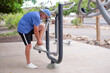 © luciano - Active senior man exercising on outdoor gym equipment in a park. Healthy lifestyle, fitness, and outdoor activity concept for older adults staying strong and active