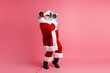 © deagreez - Santa with boombox dances in pink studio creating festive holiday energy and cheerful mood
