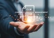 © Shayful Islam GFX - A businessman holds a glowing clm icon, representing contract lifecycle management, with a document symbol and text, highlighting the importance of efficient contract processes