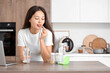 © Pixel-Shot - Young Asian woman with glass of water taking vitamin supplement in kitchen